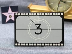 a film strip with the letter c on it next to a clock and other items