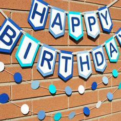 a happy birthday banner on a brick wall