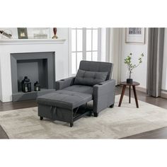 a living room with a gray recliner and fireplace