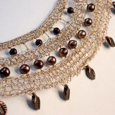 the necklace is adorned with pearls and chains