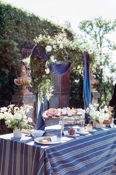 an outdoor table with blue and white decor