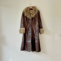 Vintage 1970s boho style chocolate brown leather coat with light brown natural fur collar and cuffs, which I believe could be Angora goat. Three button front closure, with 2 flap closure front pockets. A similar coat was worn by Kate Hudson as Penny Lane in the popular Almost Famous movie. Quilted lining with interior sewn in label for cleaning purposes.  Brand:  Unknown Color: Brown / Beige Circa:  70's Condition:  Very Good/Good Vintage Condition - Some Signs Of Wear With Scuffs & Scratches On Leather.  No Size Indicated ~ Please see measurements below. Would Work Well For Size Small - Medium and Possibly Large Made From Leather Angora Goat Fur Trim Long Sleeves With Fur Cuffs Wide Fur Collar Front Button Closoure Below The Knee Length Quilted Lined Interior Approximate Measurements:  40 Almost Famous Movie, Fur Trench Coat, Brown Leather Coat, Penny Lane Coat, Fur Trim Coat, Seventies Fashion, Penny Lane, Kate Hudson, Shearling Coat