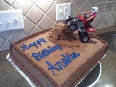 a birthday cake with a toy tractor on top