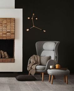 a living room filled with furniture and a fire place next to a wall mounted fireplace