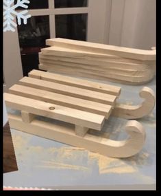 a wooden sled sitting on top of a table next to a snowflake