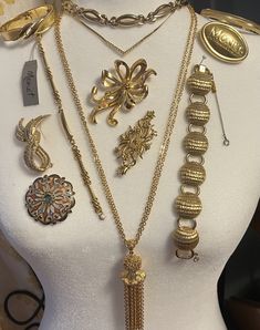 Beautiful estate collection of 12 signed Monet vintage goldtone jewelry pieces. 1950s-1980s. Includes: 3 Necklaces (1950s adjustable choker; Short length chain necklace with rhinestone chevron; 1960s long double chain necklace with chain tassel.) 4 Bracelets (1950s circle link wrap bracelet with guard chain, 1 hinged bangle, 1 bangle, 1 charm link bracelet with panel for engraving.) 5 brooches including an exclusive Monet insignia brooch (MONET New York London Paris) that was a company gift for attendees at a New York fashion show event. Very good vintage condition. Light surface wear typical of age and/or use.  You will receive the exact pieces shown in the photos. View the photos for dimensions and condition and please feel free to contact me with any questions or concerns before placing Luxury Vintage Hinged Jewelry, Monet Costume Jewelry, Double Chain Necklace, Company Gifts, Monet Jewelry, York London, Double Chain, Hinged Bangle, Antique Items