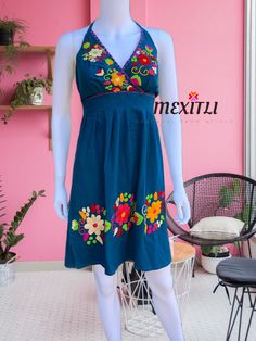 "Hand embroidered Mexican Halter dress. Made out of manta, 100% cotton. Each dress is unique, the embroidery may be slightly different from the one pictured. Color- Teal / multicolored embroidery Dimensions: Small/ Medium Bust- 41\" Hips-50\" Length- 36\" Large Bust- 45\" Hips- 52\" Length- 36\" 🧵Made in Chiapas, Mexico. 🧺Care Instructions: We recommend hand washing, air dry. 📲Please feel free to message me with any questions regarding sizing and fit. 📷Additional photos can be provided upon Bohemian Cotton Dress With Machine Embroidery, Traditional Cotton Dresses With Floral Embroidery, Multicolor Embroidered Cotton Dress For Beach, Cotton Embroidered Dress For Beach, Cotton Dress With Floral Embroidery For Festival, Cotton Embroidered Dress For The Beach, Multicolor Cotton Dress With Embroidered Neckline, Traditional Sleeveless Cotton Embroidered Dress, Bohemian Cotton Dress With Multicolor Embroidery