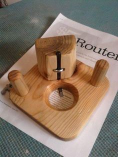 a small wooden device is sitting on top of a piece of paper that says router