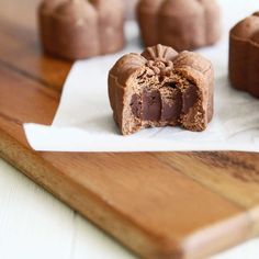 chocolate desserts sitting on top of a wooden cutting board