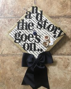 a graduation cap with the words at the story goes on it and a black bow