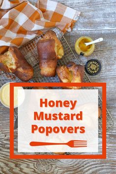 honey mustard popovers on a wire rack next to butter and lemons, with the words honey mustard popovers above it