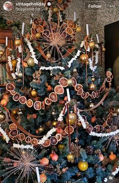 a decorated christmas tree with oranges and other decorations