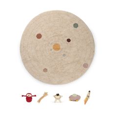 an assortment of toy animals sitting in front of a round rug with circles on it