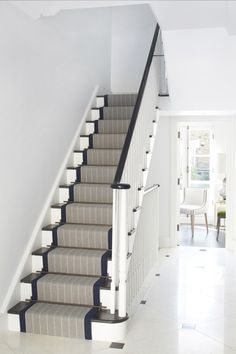 a staircase with carpeted steps leading up to the second floor