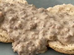 biscuits covered in gravy sitting on top of a table