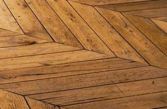 an image of wood flooring that looks like herringbones or chevron lines