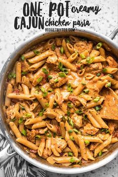 one pot creamy cajun chicken pasta in a skillet with the title above it