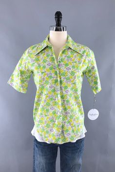 >> Shop our full collection! >> THISBLUEBIRD.COM Cute vintage 1960s to 1970s button down blouse in bright green and yellow floral print. In excellent condition. Poly cotton blend. Tag size 12-32. No stretch. Shown on XXS/XS dress form. Refer to measurements and leave room for ease of movement.   Bust - 38 inches Waist - 36 inches Hips - 38 inches Length - 25 inches Sleeves - 10.5 inches Shoulders - 15.5 inches Please review all photos in full.  SKU: 9006911   >> Shop our FULL COLLECTION << https://thisbluebird.com Subscribe to our newsletter for shop updates and coupon codes: https://thisbluebird.com/subscribe Looking for vintage men's clothing and accessories?  Check out our partner shop Fyve by Fyve! http://www.fyvebyfyve.etsy.com >> SHIPPING OUTSIDE THE USA << For all items being shippe Green Retro Print Shirt For Spring, Green Vintage Print Blouse For Spring, Green Tops With Vintage Print, Spring Green Blouse With Vintage Print, Green Collared Top With Retro Print, Retro Green Collared Shirt, Green Retro Print Blouse For Summer, Fitted Green Tops With Retro Print, Fitted Green Top With Retro Print