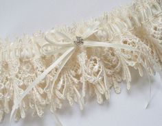 Ivory Garter with Double Ivory Ribbon Bow and Margarita Crystal Center - The ROCKY Garter Elegant Bridal Accessories With Delicate Lace For Ceremony, Elegant Scalloped Lace For Brides, Elegant Delicate Lace Bridal Accessories For Ceremony, Elegant Cream Lace For Wedding, Elegant Cream Lace For Bride, Elegant Cream Wedding Lace, Elegant Beige Lace For Wedding, Adjustable Cream Bridal Accessories For Ceremony, Cream Lace Bridal Accessories For Wedding