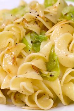 pasta with broccoli and cheese on a white plate