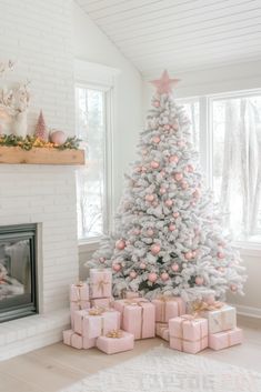 a white christmas tree with pink and gold presents