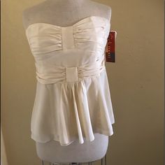 Gorgeous With Tags, Nanette Lepore Dressy Cream Strapless Blouse, With Back Strap To Keep It Sitting On Your Bust. It Says A Size 12. The Front Is Pleated At The Bust With A Built In Waist Belt And A Loose Front Panel. The Back Zoos Up. Bust 36” Waist 30” Length 19”. It Is Lined And In Mint Condition. Sexy, Classy And Pretty. It’s Silk And Polyester Chic Camisole With Corset Back For Night Out, Strapless Flirty Corset With Built-in Bra, Flirty Strapless Corset With Built-in Bra, Summer Strapless Camisole With Boned Bodice, Summer Evening Tube Top With Corset Back, Strapless Summer Camisole With Boned Bodice, Summer Evening Tube Top With Boned Bodice, Chic Strapless Tube Top With Boned Bodice, Boned Bodice Tube Top For Summer Evenings