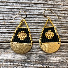 "These beaded brass teardrop shaped earrings were handwoven one bead at a time with size 11/0 Miyuki glass seed beads. A time intensive and intricate craft, each bead is carefully hand stitched in order to create an evenly woven beaded fabric. The process requires focus, patience and dedication, as even a small pair of beadwork earrings can take hours to complete. I love the contrast with the matte and shiny beads... my favorite! Handwoven Brick Stitch Beadwork Miyuki delica glass seed beads in 24k gold plated matte and shiny 14k gold filled ear wires and findings Raw brass pieces + gold plated triangle Extra durable nylon beading thread Each bead is approx. 1.6mm x 1.3mm Size: 1 1/2\" long (including ear wire) and 3/4\" wide Weight: 2g each (4g/pair)" Handmade Black Bohemian Teardrop Earrings, Adjustable Handwoven Teardrop Jewelry, Handwoven Teardrop Earrings For Festivals, Artisan Handwoven Teardrop Jewelry, Bohemian Black Teardrop Beaded Earrings, Gold Teardrop Earrings With Tiny Beads, Adjustable Teardrop Earrings With Gold Beads, Handwoven Black Drop Earrings, Black Handwoven Drop Earrings