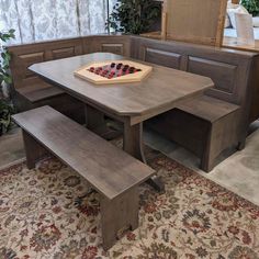 a wooden table with two benches and a chess board on it