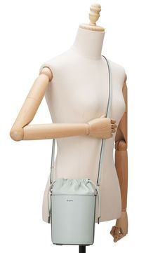 A scaled-down bucket bag with a modern silhouette is crafted of smooth leather offering optional wear with top carry handle or an adjustable, crossbody strap. 6"W x 9"H x 5"D 24" strap drop Drawstring closure Top carry handle; removable, adjustable crossbody strap Lined Leather Imported Spring Bucket Bag With Adjustable Strap For On-the-go, Modern Bucket-shape Satchel With Adjustable Strap, Spring Bucket Bag With Detachable Strap And Double Handle, Modern Bucket Bag With Adjustable Handle, Modern Satchel Bucket Bag With Adjustable Handle, Modern Bucket Bag With Adjustable Handle For Shopping, Spring Bucket Bag With Removable Pouch And Double Handle, Modern Shopping Bucket Bag With Adjustable Handle, Spring Leather Bucket Bag With Removable Pouch