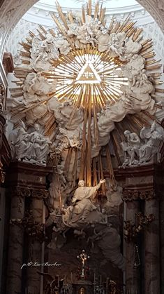 the inside of a church with statues and lights