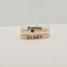 Show off your name and birthstone in style with this stunning Stacking Name Ring Set! Includes 4 stackable rings: a sterling silver beaded ring, a fine silver name ring, a 14K gold-filled birthstone ring, and a 14K gold-filled name ring Perfect personalized gift for mom, wife, daughter, sister or friend Name ring beautifully displays any name or date in elegant lowercase script and modern typewriter font Choose your personalized birthstone to represent your birthday month This one-of-a-kind ring Gold Sterling Silver Stackable Engraved Ring, Stacked 14k Gold Jewelry For Anniversary, Adjustable Stacked Sterling Silver Jewelry, 14k Gold Silver Stackable Rings With Birthstone, Stackable Sterling Silver Midi Rings, Fine Jewelry Sterling Silver Stackable Engraved Ring, Sterling Silver Stackable Engraved Ring, Fine Jewelry Engraved Sterling Silver Stackable Ring, Hand Stamped 14k Gold Jewelry For Promise Ring