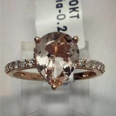 an engagement ring with a large brown and white diamond in the center, on display