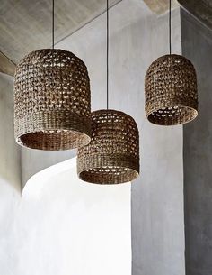 three woven lamps hanging from the ceiling