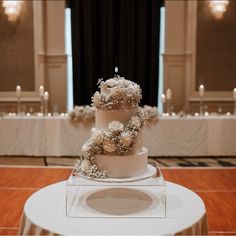 a three tiered cake sitting on top of a table