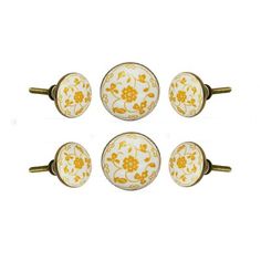 four yellow and white knobs with flowers on them