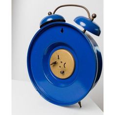 a blue alarm clock sitting on top of a white table