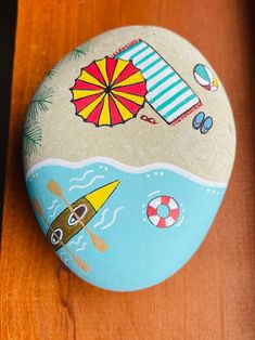 a painted rock sitting on top of a wooden table