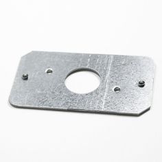 a metal plate with holes in it on a white surface