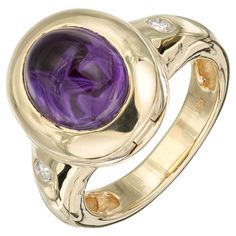 Amethyst and diamond ring. 1 oval cabochon amethyst set in 14k yellow gold with 2 round brilliant cut diamonds. Crown of ring opens up. 1 oval cut cabochon purple amethyst, VS 10.5mm x 8.5mm 2 round brilliant cut diamond, G SI2 approx. .10cts Size 7.5 and sizable 14k yellow gold Stamped: 14k 10.2 grams Width at top: 15.8mm Height at top: 9.5mm Width at bottom: 4.7mm Yellow Gold Cocktail Ring, Amethyst Set, Amethyst And Diamond Ring, Yellow Gold Diamond Ring, Bezel Set Ring, Yellow Gold Setting, Gold Band Ring, 18k Yellow Gold Ring, Set Ring