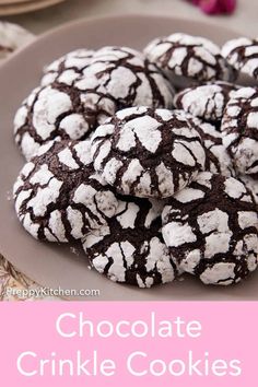 chocolate crinkle cookies on a gray plate with pink and white flowers in the background