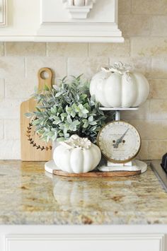 a kitchen counter top with white pumpkins on it and an open sign that says autumn is the air home tour