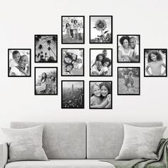 a living room with a couch and many pictures on the wall above it, all in black and white