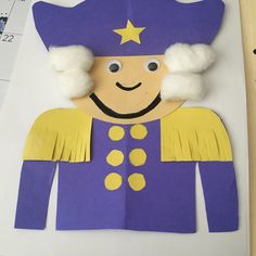 a paper doll made to look like a man wearing a blue hat and yellow outfit