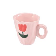 a pink cup with a flower painted on it