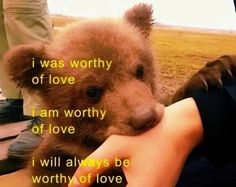 a teddy bear being held by someone's hand with the words i was worthy of love