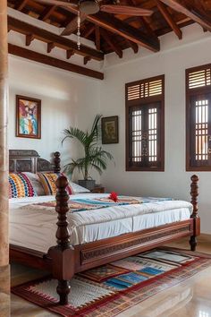 a large bed sitting in the middle of a bedroom next to two windows with shutters