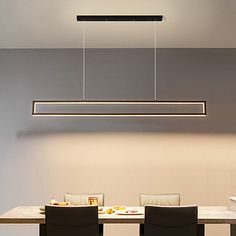 a dining table with four chairs and a rectangular light fixture hanging from the ceiling above it