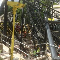 the roller coaster is being worked on by workers