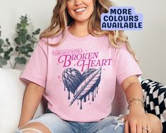 I can do it with a broken heart! This t-shirt with a navy & pink illustration serves as a reminder of your own resilience and strength even in the face of heartbreak. Whether it's a daily dose of encouragement for yourself or a heartfelt gift for a friend, this cosy tee is perfect and oh so comfy! DETAILS: Our t-shirts are handmade to order, using DTF transfers on Gildan 5000 t-shirts for a high quality and long lasting result. T-shirts are 100% Cotton and a unisex fit. They are available in siz Pink Heart-shaped Graphic Print T-shirt, Relaxed Fit Pink T-shirt With Heart Graphic, Pink Illustration, Pop Culture Tshirts, Rose T Shirt, Heart T Shirt, I Can Do It, Dtf Transfers, Navy Pink