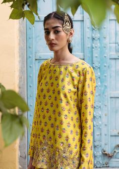 Editor's Note Bask in the brilliance of our sunshine yellow printed dupion silk kurta, elevated by hand-embroidered detailing. This ensemble exudes charm and sophistication. Paired harmoniously with printed kali pants, it's a perfect fusion of style and comfort, making it an exquisite choice for any occasion. Fabric: Dupion silk, net Color: Yellow Components: Kurta and sharara Occasion: Festive Disclaimer: Product color may slightly vary due to photographic lighting sources or your monitor setti Blouse Yoke, Personal Shopping Service, Short Kurta, Silk Kurta, Dupion Silk, Sunshine Yellow, Yellow Shorts, Yellow Print, Floral Print Shorts